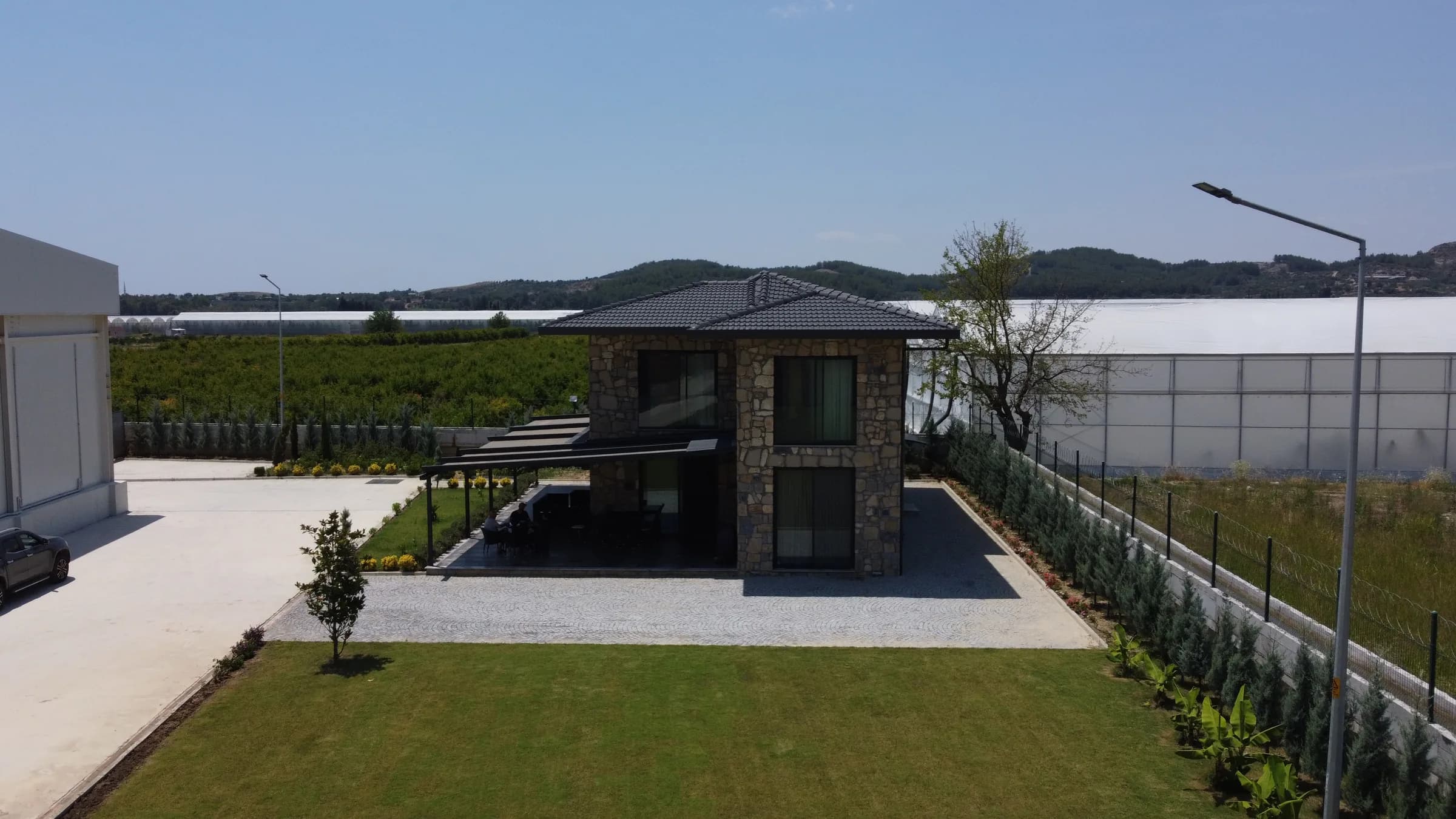 Fabrika bahçesindeki taş villanın ön görünümü